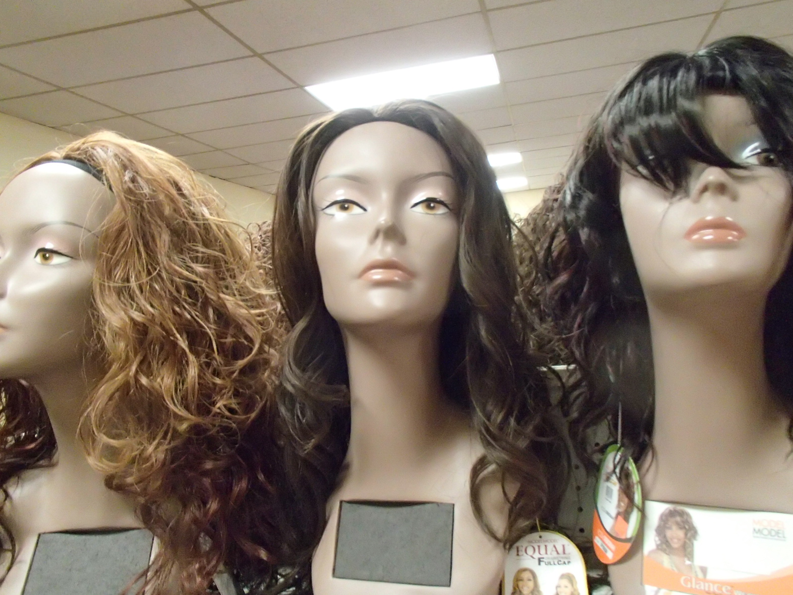 Wigs on top of fake heads.